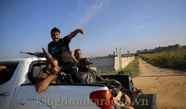 Palestinian militants drive back to the Gaza Strip with the body of an Israeli soldier on Saturday, October 7, 2023